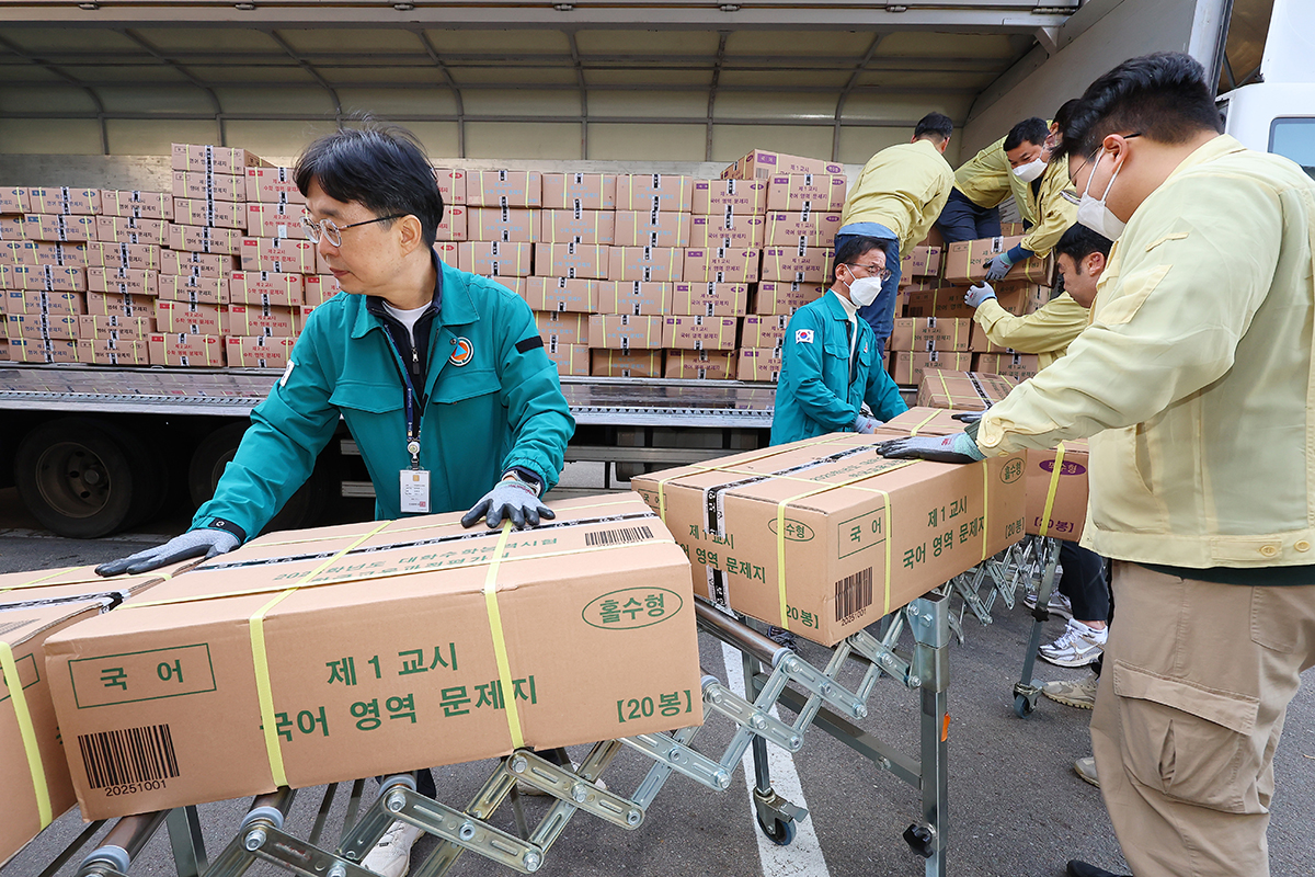 Staff from the Incheon Metropolitan City Office of Education on Nov. 12 move boxes of exam sheets for the 2025 College Scholastic Ability Test in front of a warehouse in the city. 